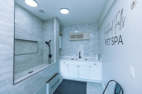 A white bathroom with a sign that says Pet Spa.
