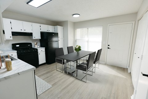an open kitchen and dining room with a table and chairs
