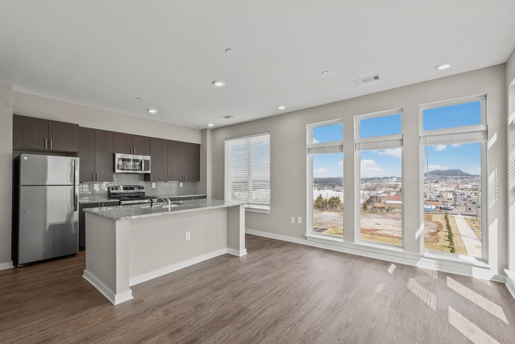 a kitchen with a large window and a view of a city