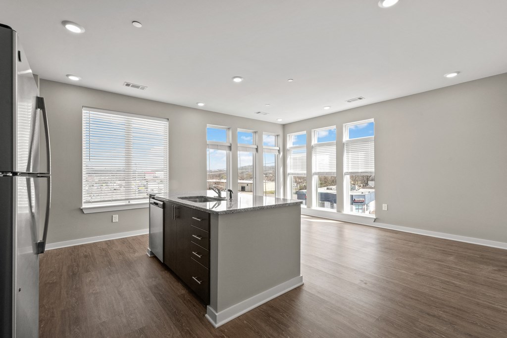 a kitchen with hardwood floors and grey walls