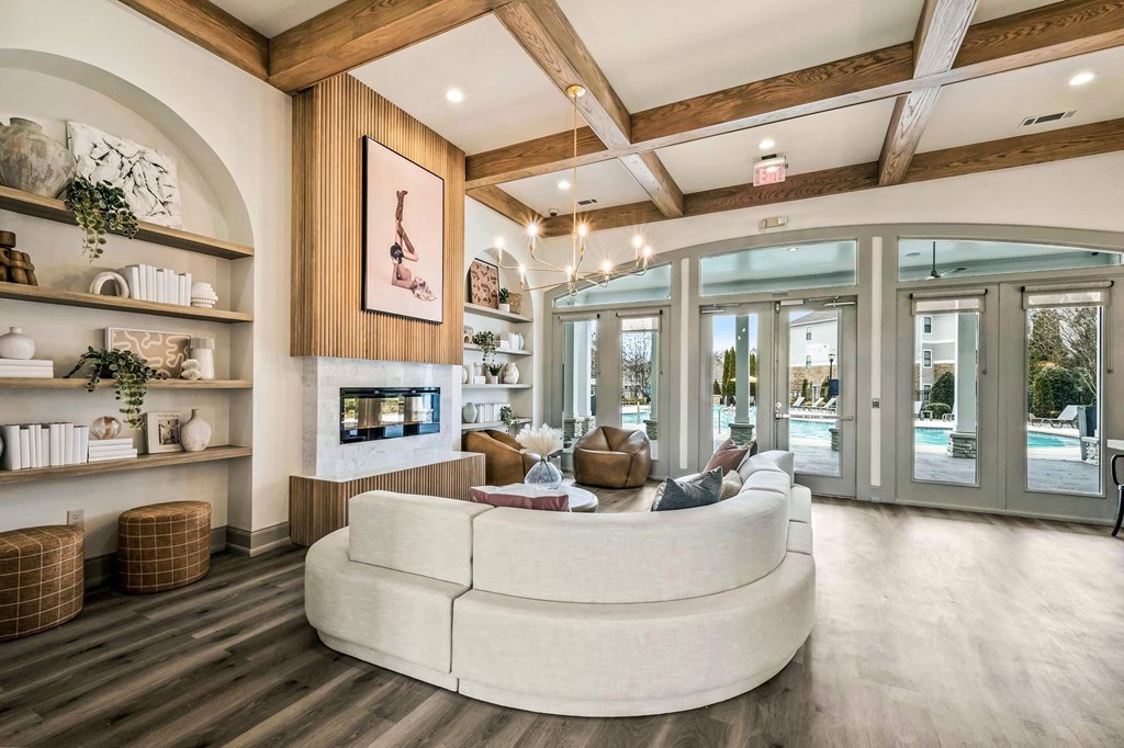 a living room with a large white couch and a fireplace