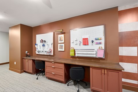 A brown desk with a chair and a cabinet with drawers.