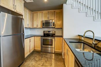 a kitchen with stainless steel appliances and wooden cabinets at 2100 Acklen Flats, Nashville, Tennessee