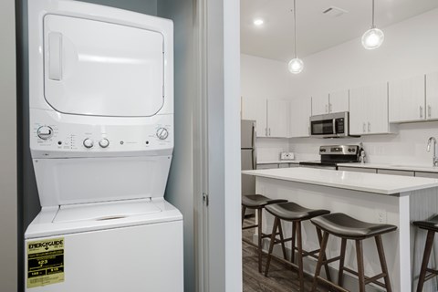 A white oven with a sticker on it is in a kitchen.