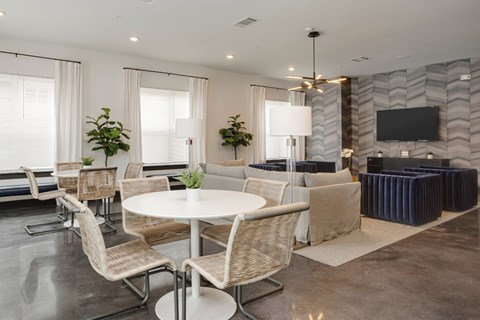 A modern dining room with a white table and chairs.
