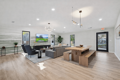 A modern living room with a black chair and a wooden coffee table.