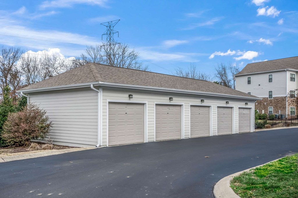a garage with white doors and a roof