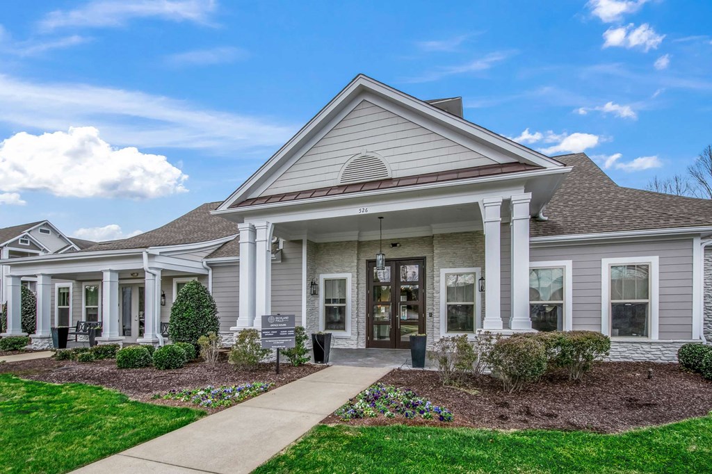 the front of a house with a sidewalk and grass