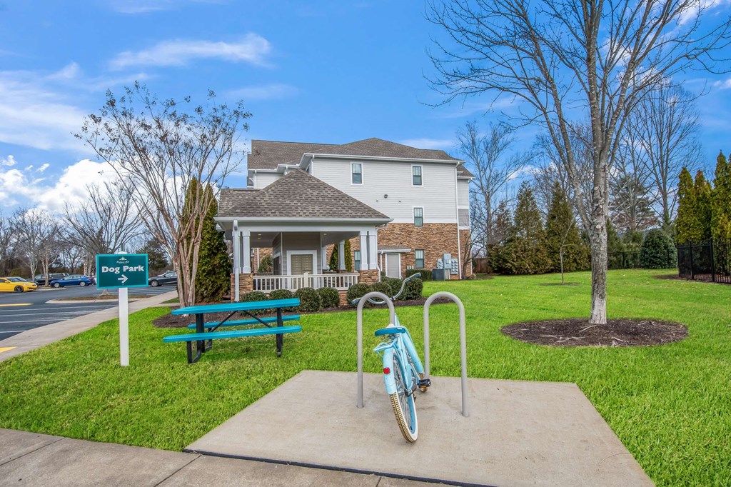 a bicycle parked at a playground in front of a house