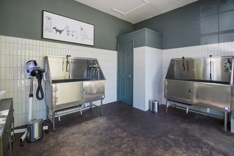 A kitchen with two sinks and a trash can.