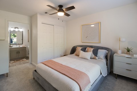 a bedroom with a bed and a ceiling fan