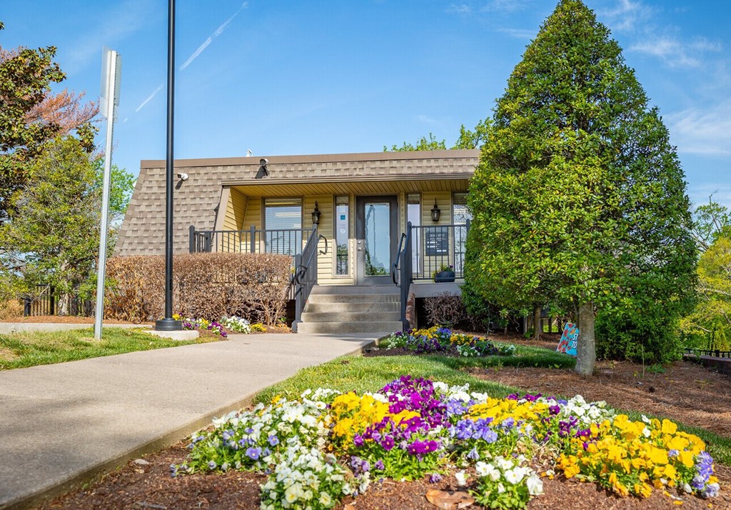 A house with a garden in front of it.