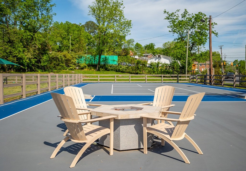A table and chairs set up on a tennis court.