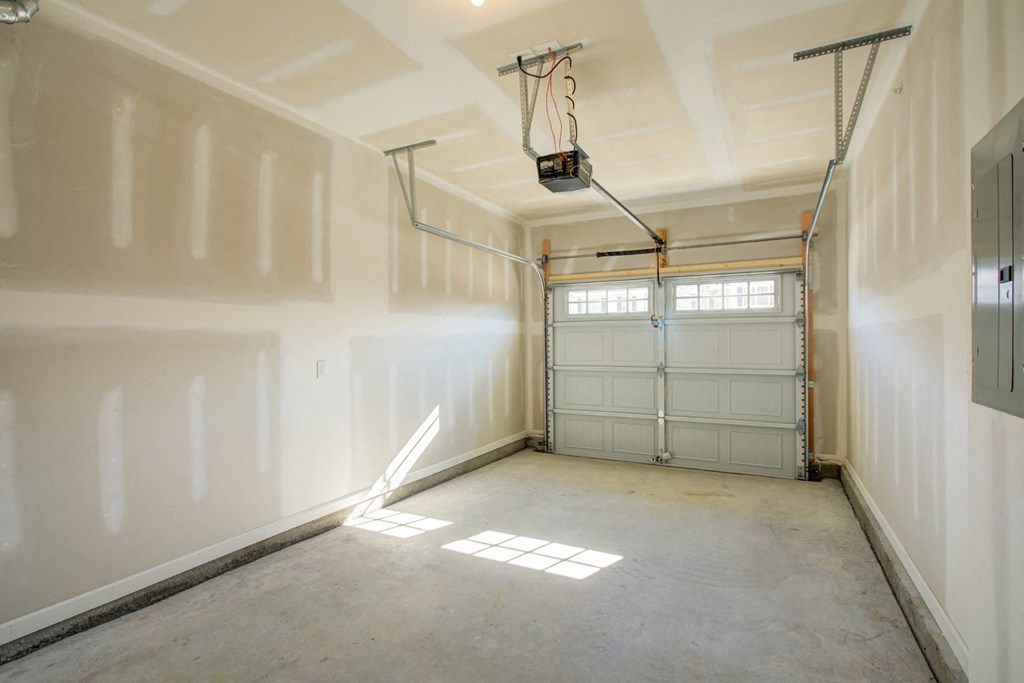 a garage with a white door and white walls