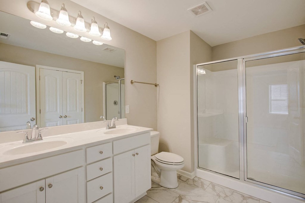 a bathroom with a shower toilet and sink