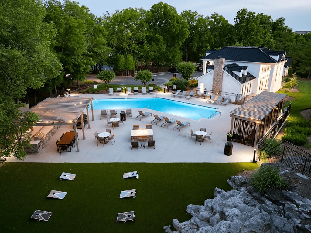A backyard with a pool and a deck.