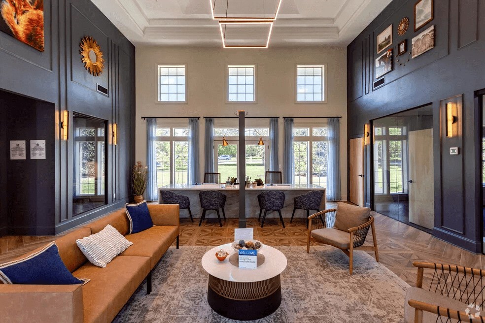A living room with a brown couch and a coffee table.