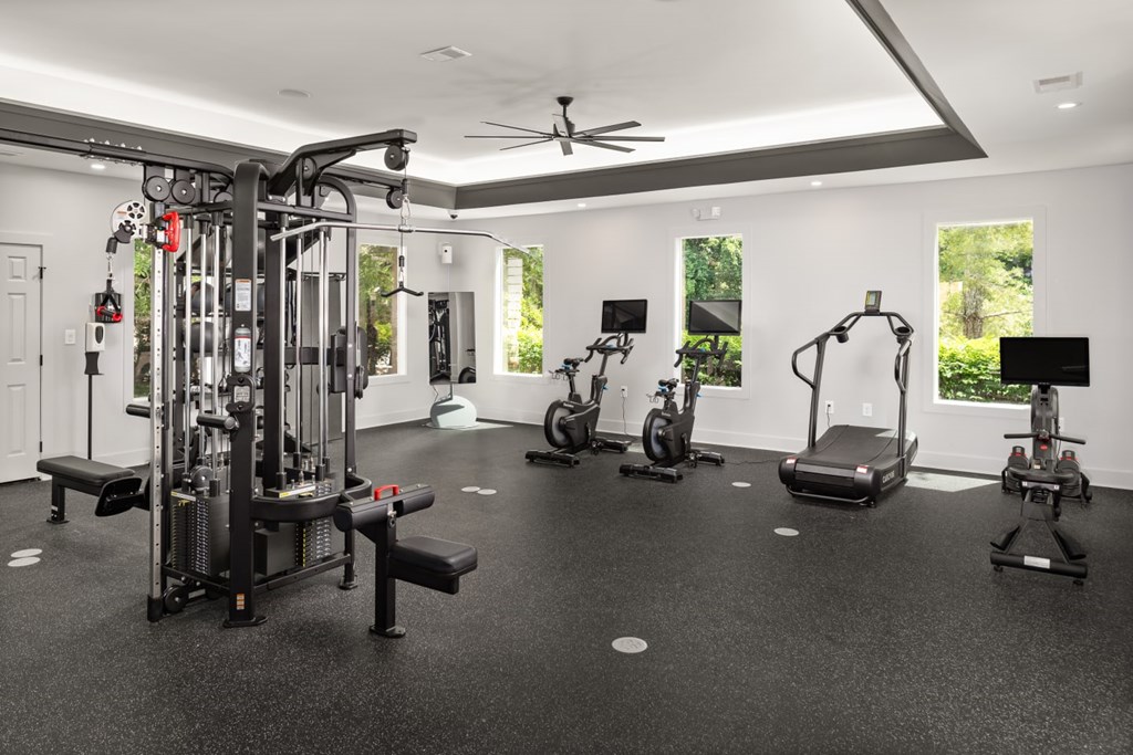 A spacious home gym with a variety of equipment.