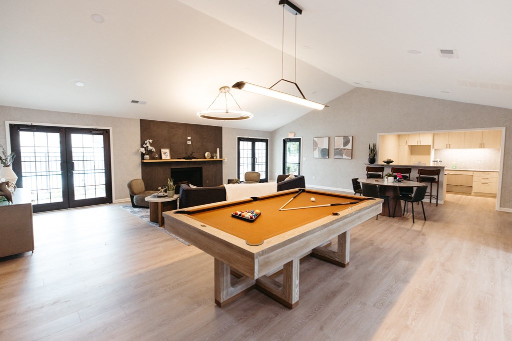 a pool table in the center of a living room
