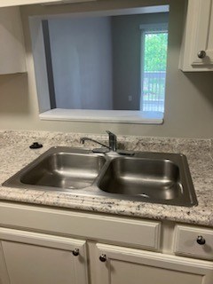 A kitchen with a sink and a window.