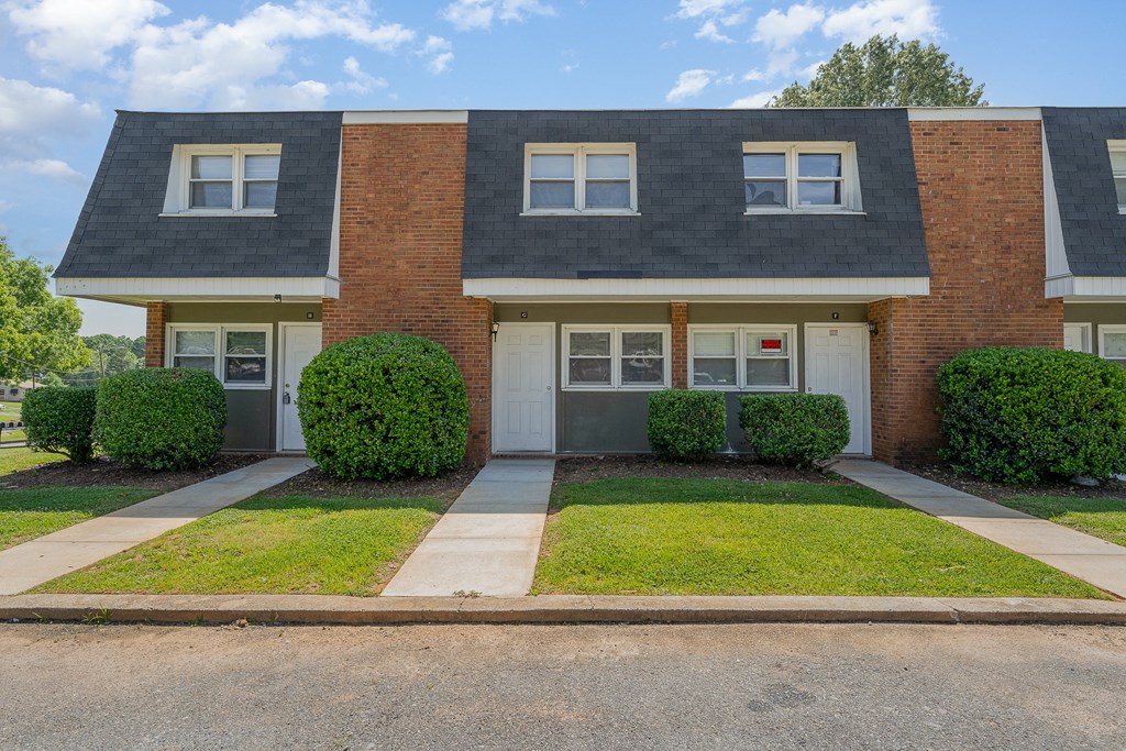 a home with a gray roof and a white garage door
