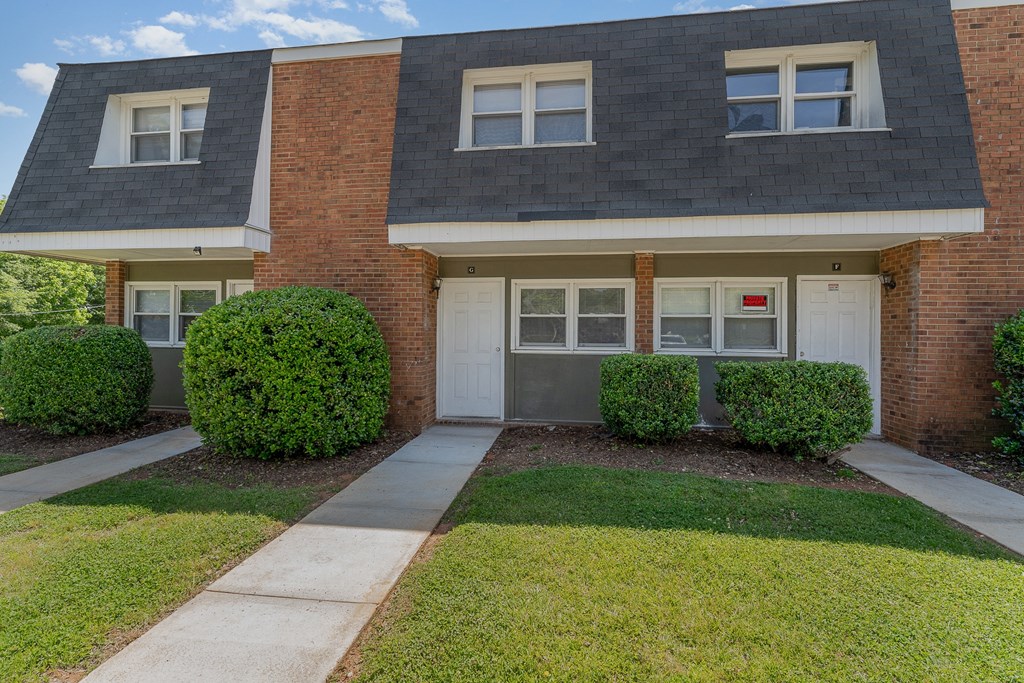 a house with a white garage door and a green lawn