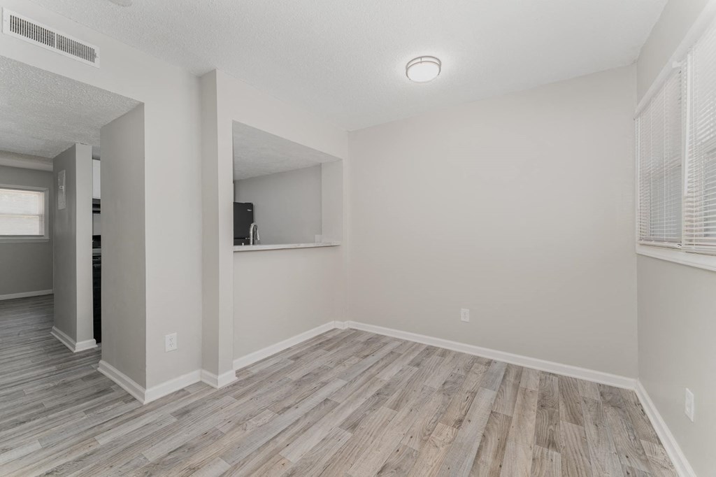the spacious living room with hardwood floors at the whispering winds apartments in pearland, tx
