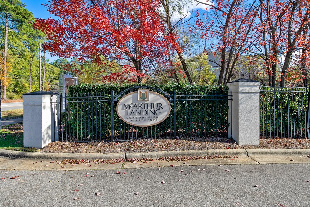 the entrance to the magnolia landing neighborhood in front of a wrought iron driveway gate