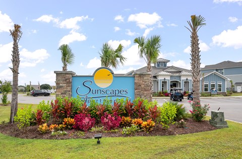 the suncapes sign in front of a building with palm trees