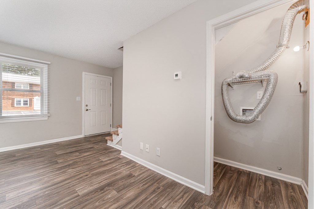 a bedroom with hardwood floors and grey walls