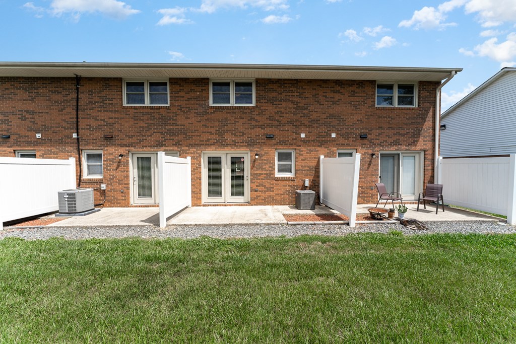 a large brick house with a lawn in front of it