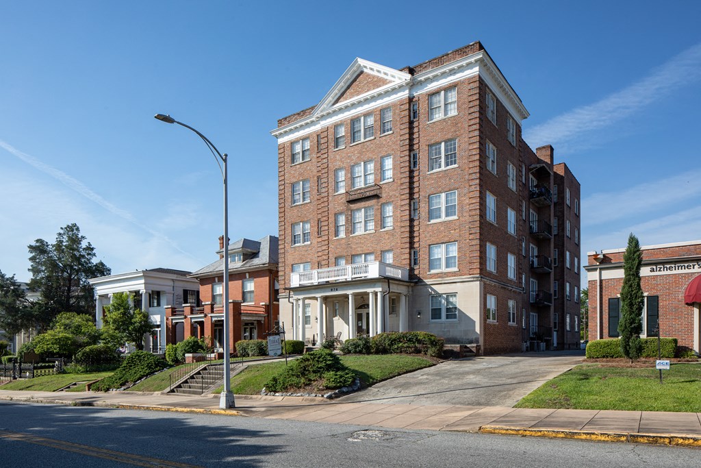 a brick apartment building on a street corner