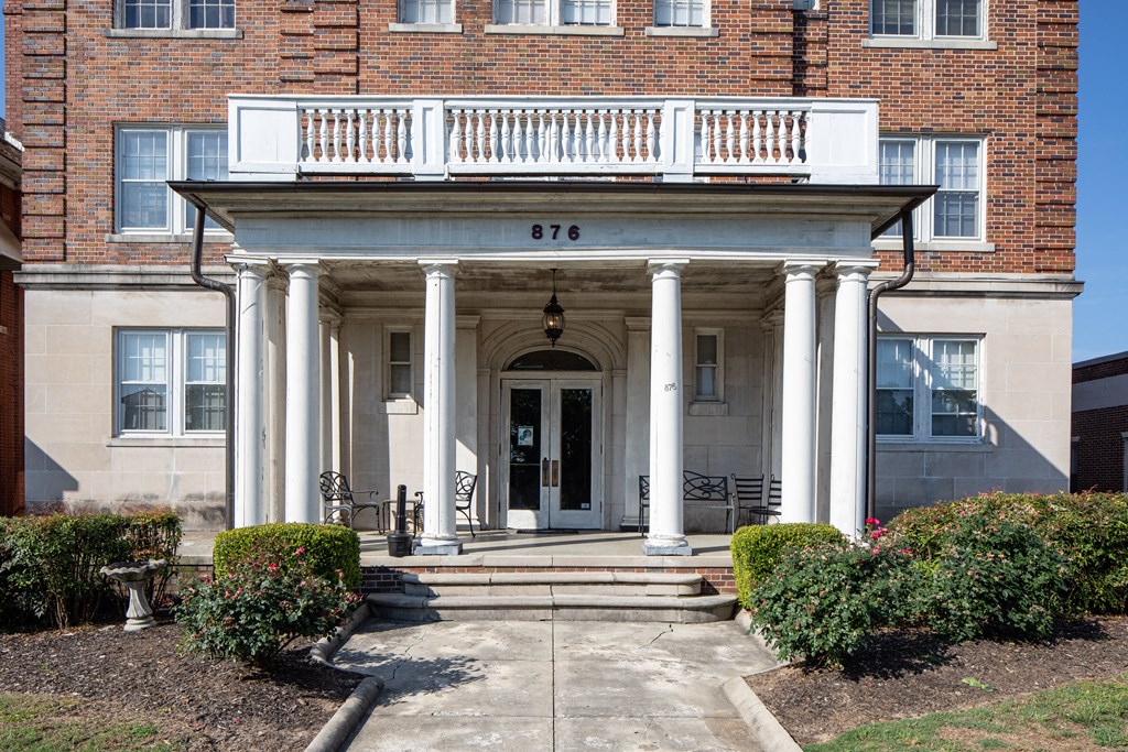 the front of a building with columns and a porch