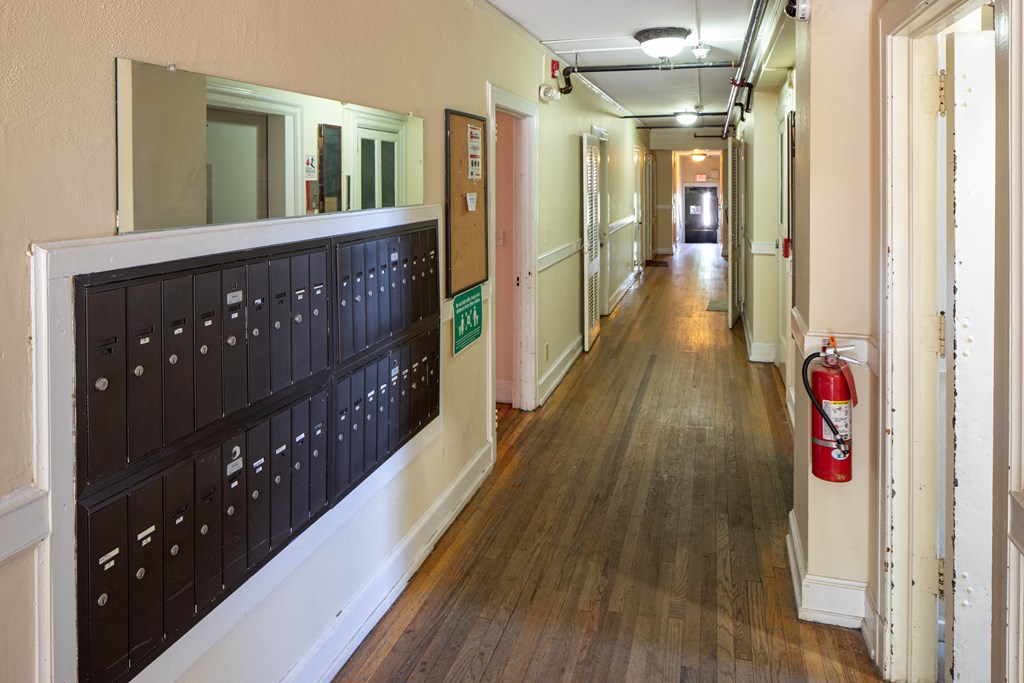 a hallway with a fire hydrant and a bulletin board on the wall and a