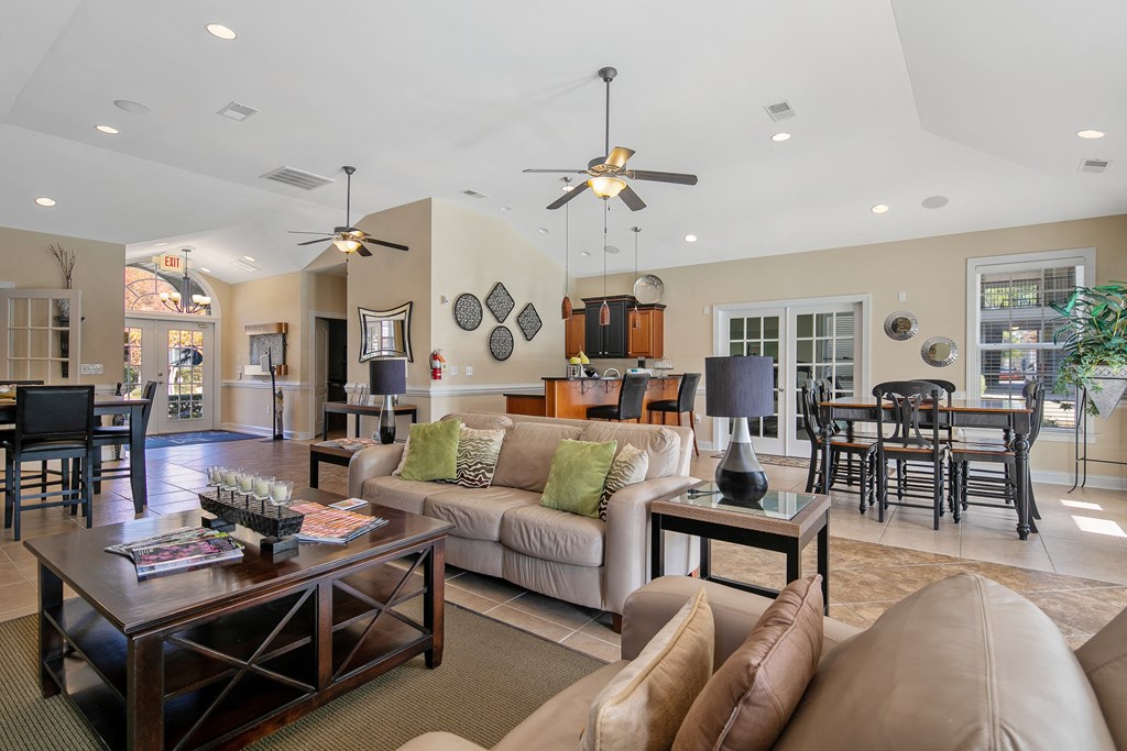 a living room and dining room with couches and a table