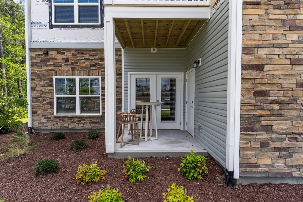A house with a white door and a window is shown.