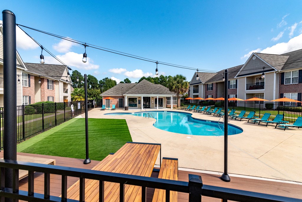 our apartments have a large pool and deck with chairs