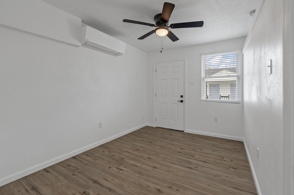 the living room of our studio apartment atrium with a ceiling fan