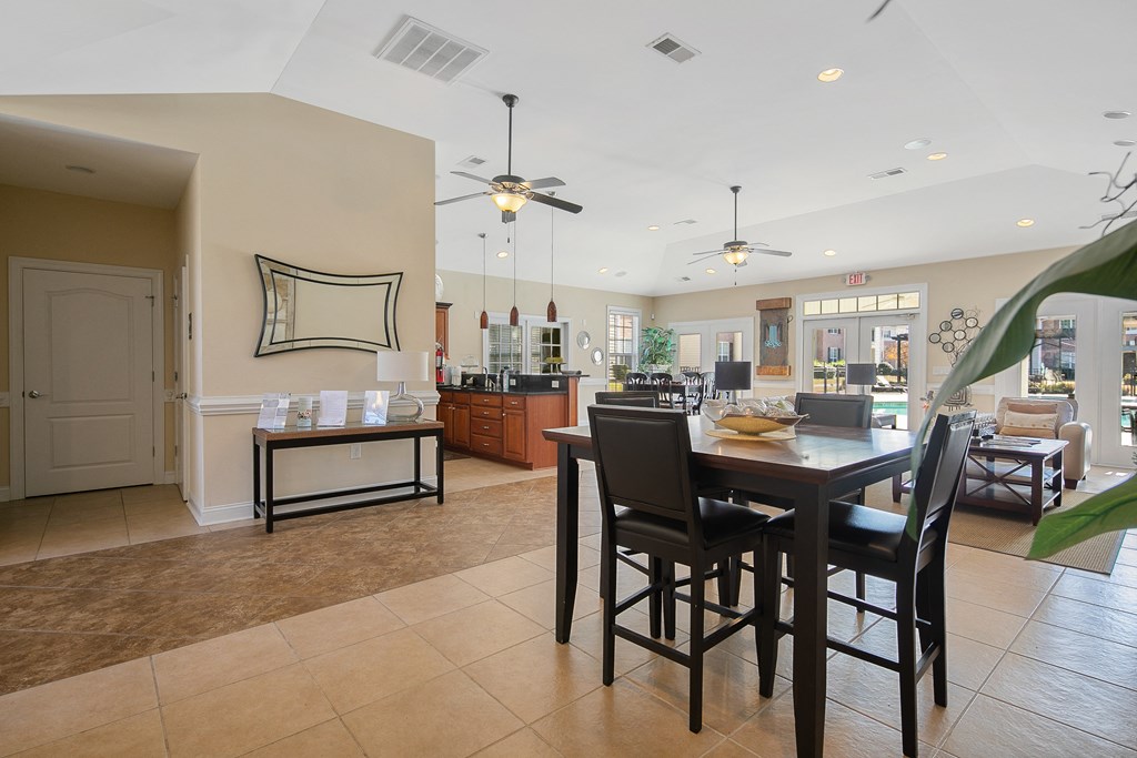 a dining room and living room with a table and chairs