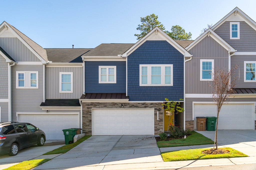 a blue and white house with a garage door