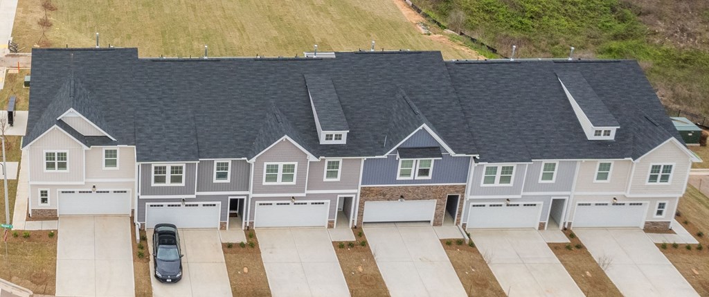 an aerial view of a house with a roof and garage doors