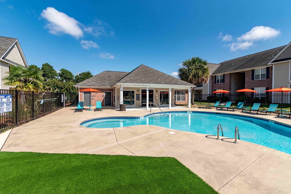 our apartments have a large pool and a house with chairs