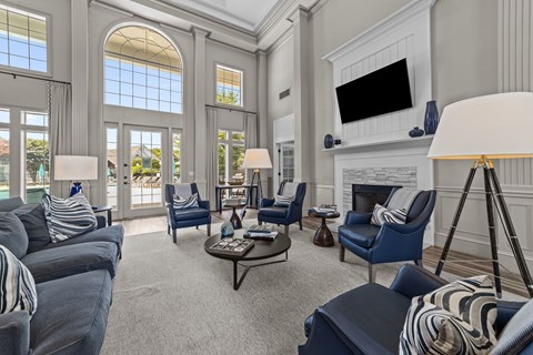 A living room with a grey sofa and blue chairs.