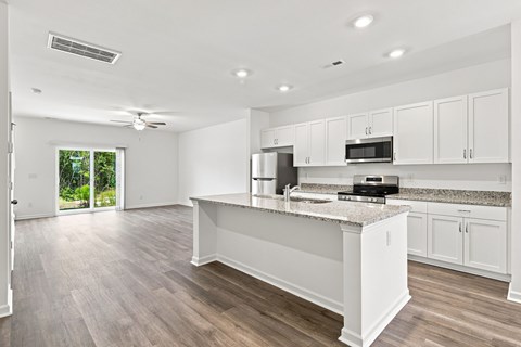 A kitchen with white cabinets and a countertop.