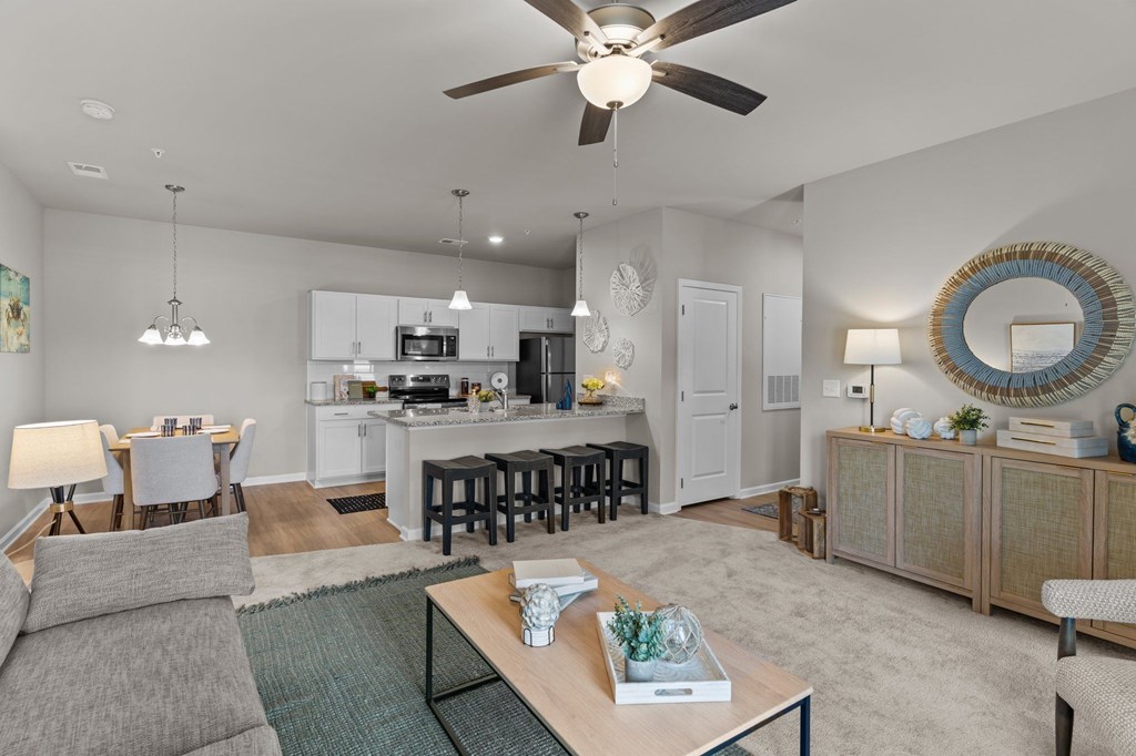 A modern living room with a grey sofa and a wooden coffee table.