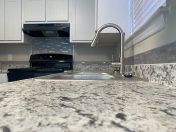 Granite Countertops white shaker cabinetry; stainless steel fixtures, affordable apartments - Photo Gallery 5