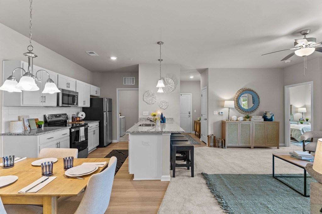 A modern kitchen with a dining table set for two.