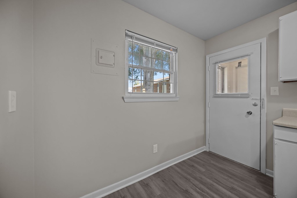 A room with a window and a door.