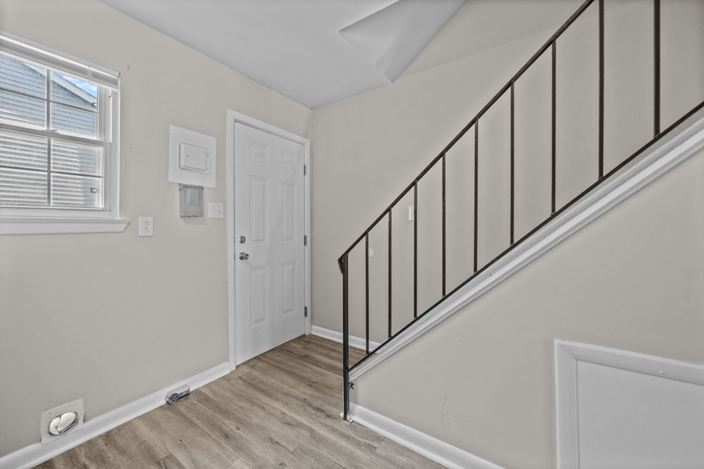 A staircase with a black railing and wooden steps.