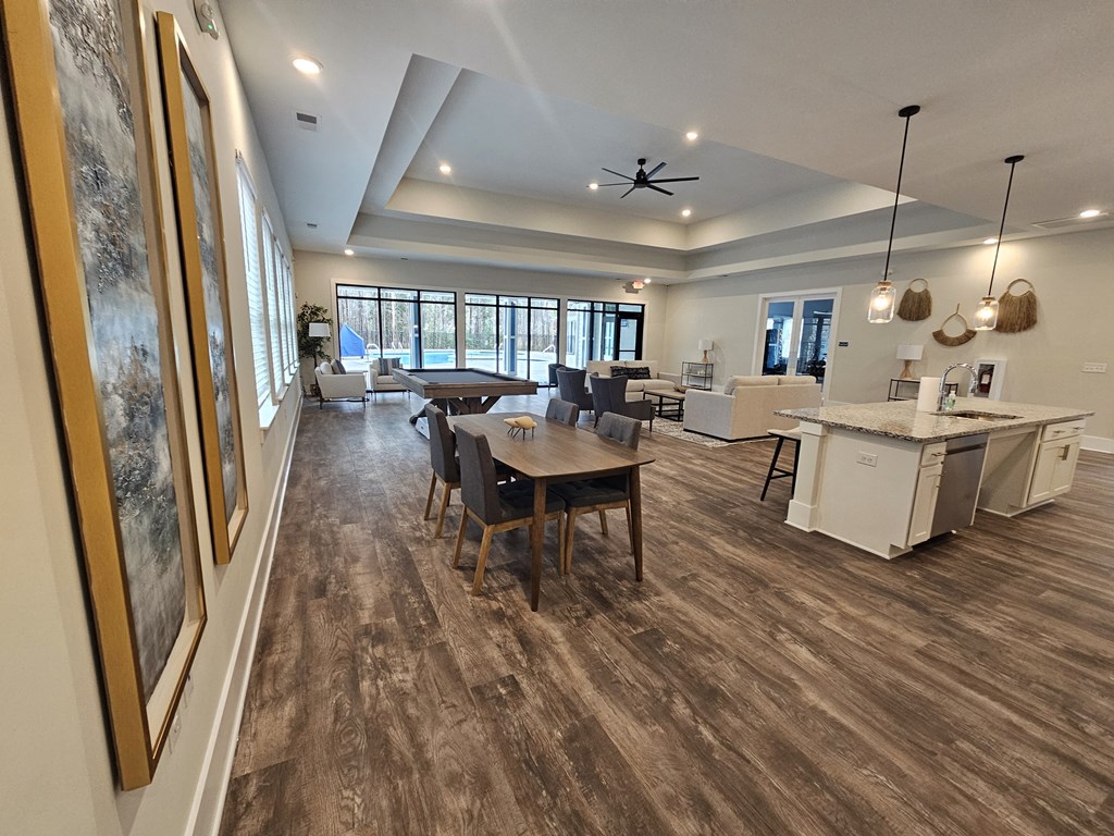 A spacious room with a dining table and chairs.